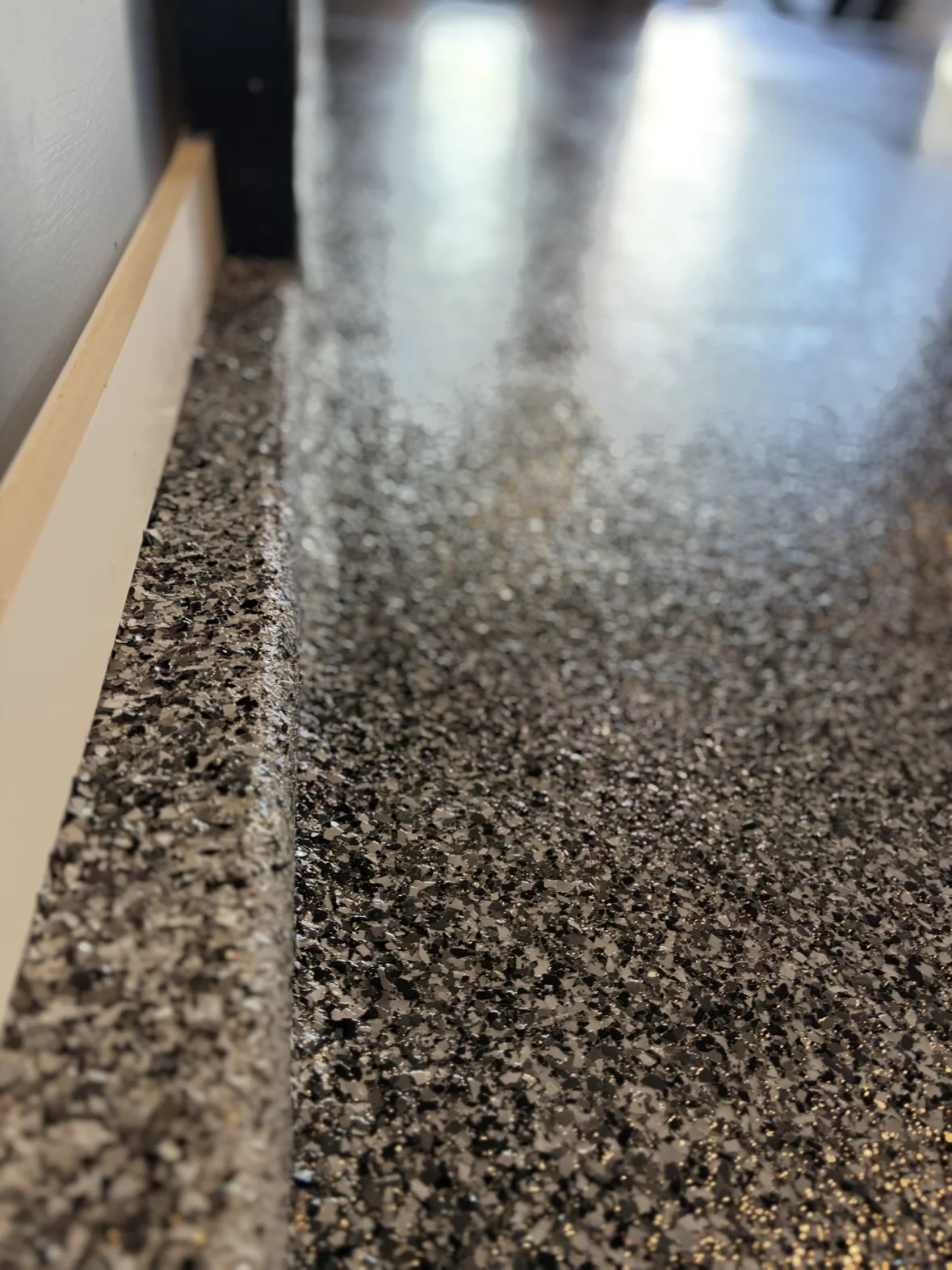 Decorative flake epoxy finish at a residential floor threshold