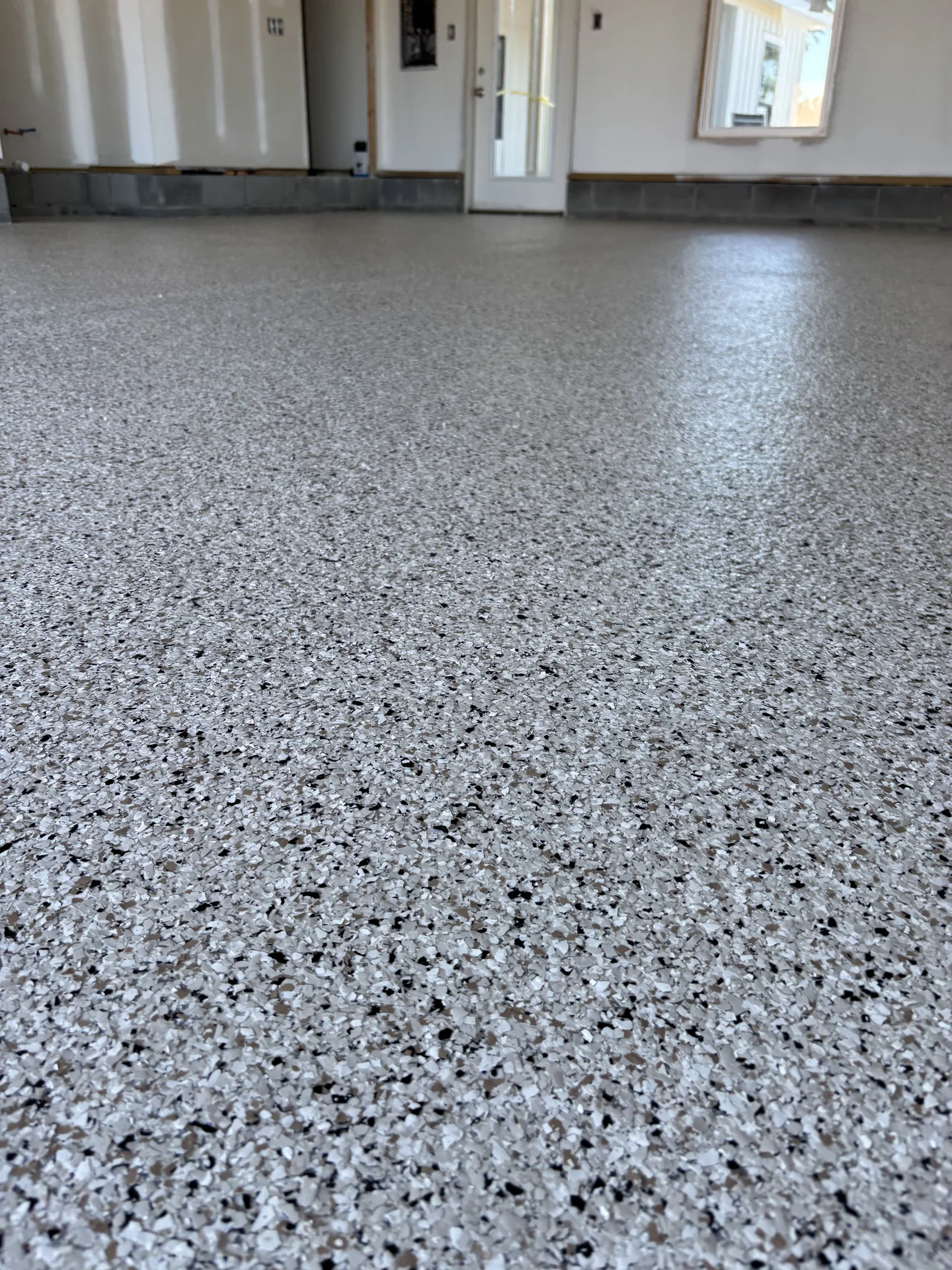 Gray flake epoxy floor across an open residential interior
