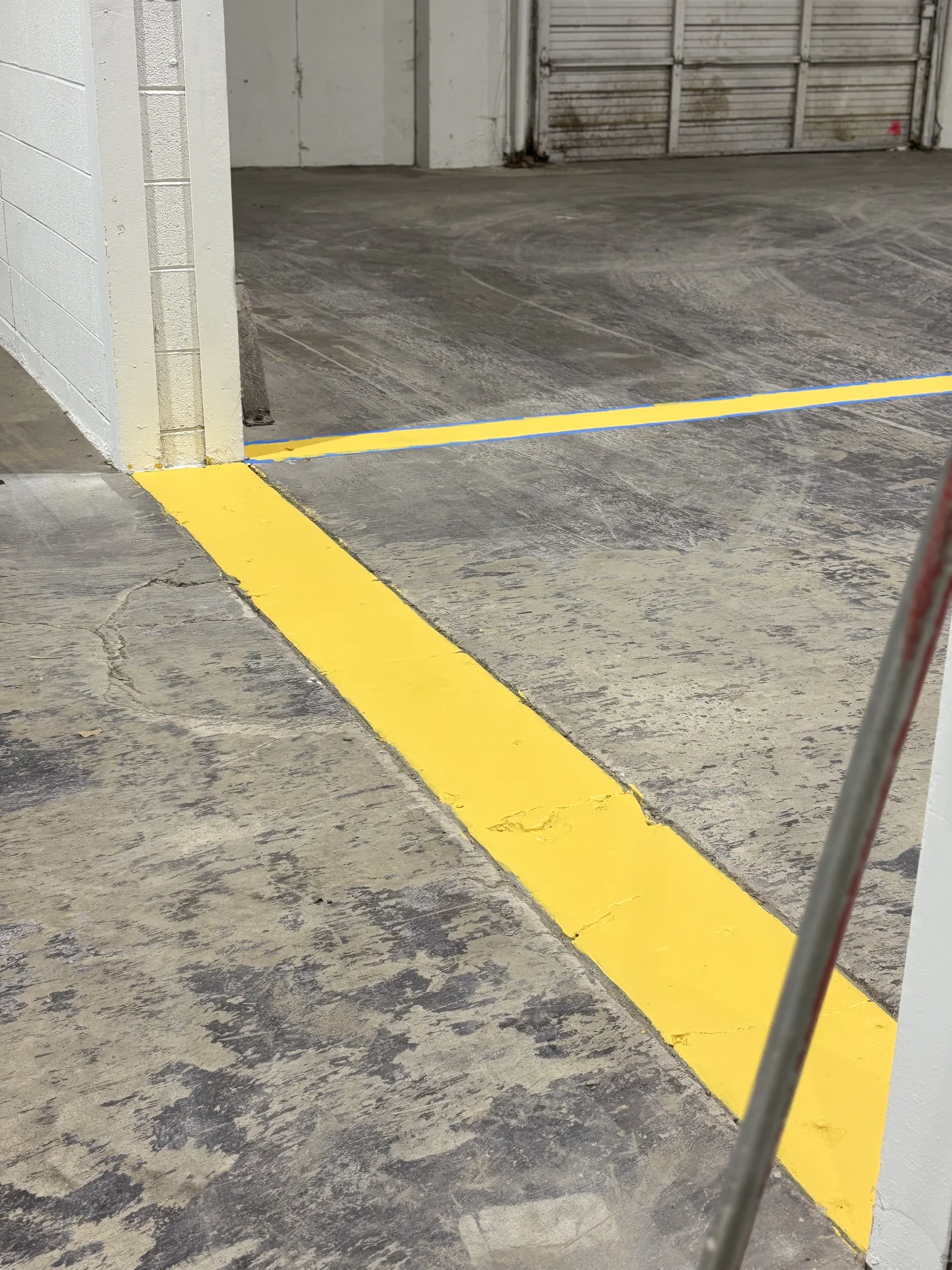 Yellow floor marking turning around a warehouse column