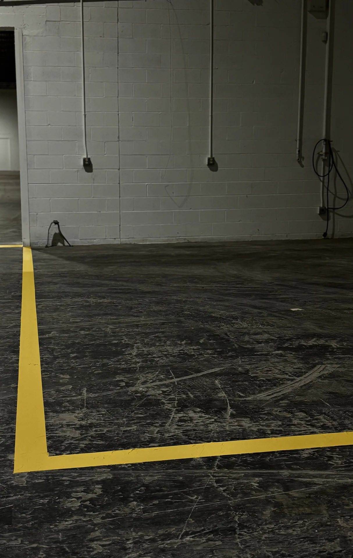Yellow floor markings outlining a warehouse work area