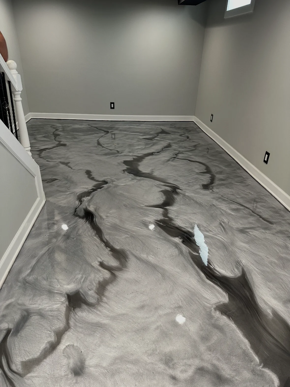 White and charcoal metallic floor in a residential room