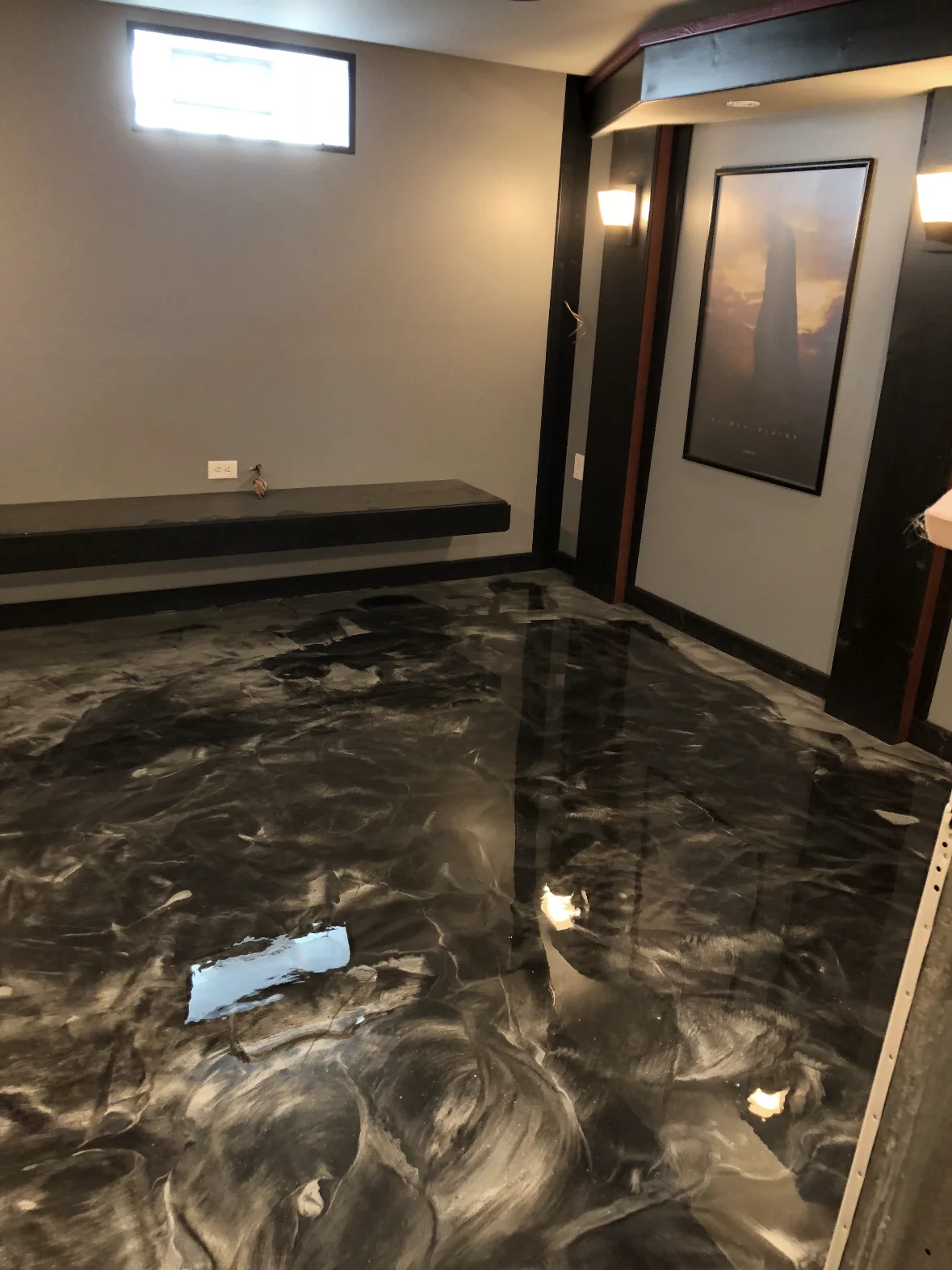 Dark metallic floor detail near an interior doorway