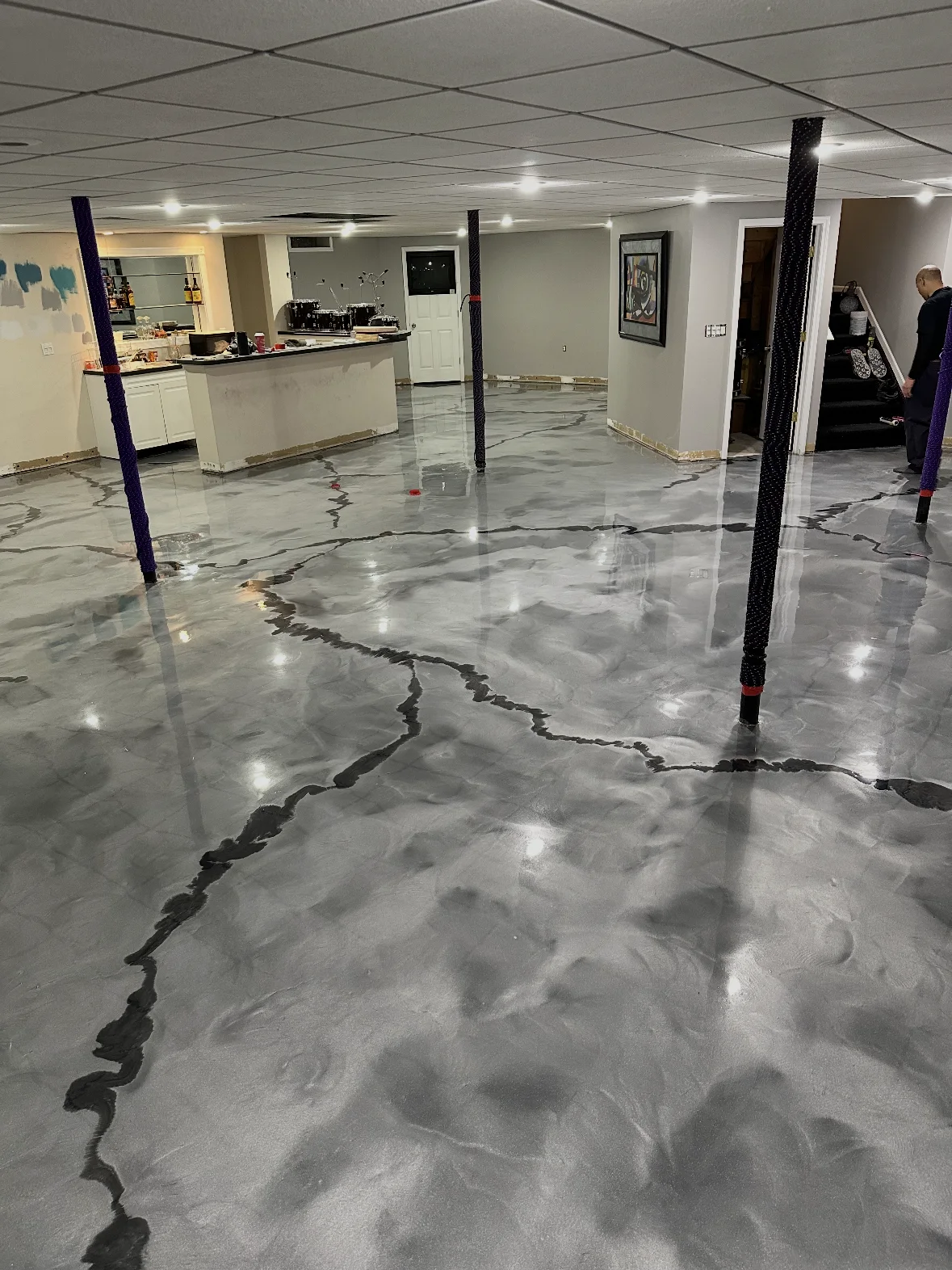 Gray metallic finish across a large basement floor