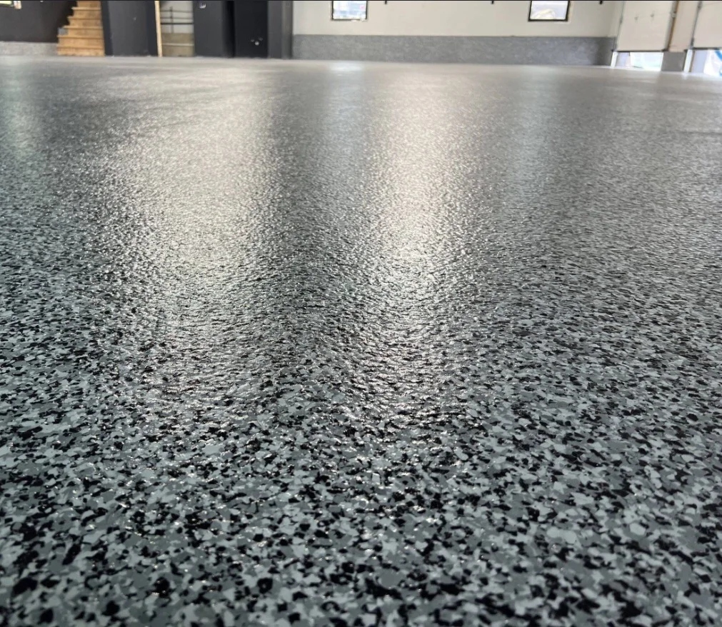 Close view of a gray decorative flake residential garage floor