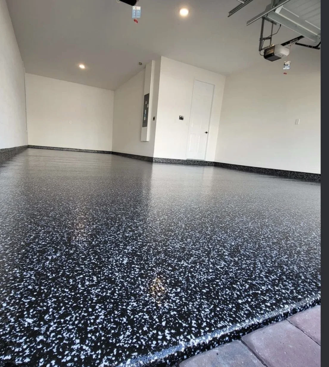 Finished residential garage with a gray flake coating