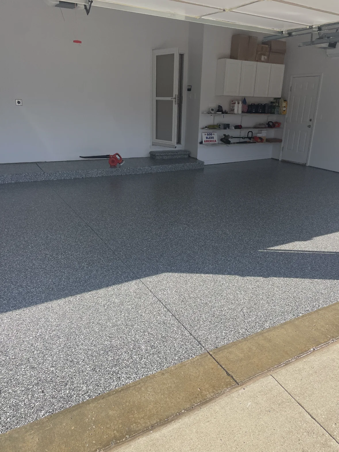 Residential garage floor during decorative flake installation