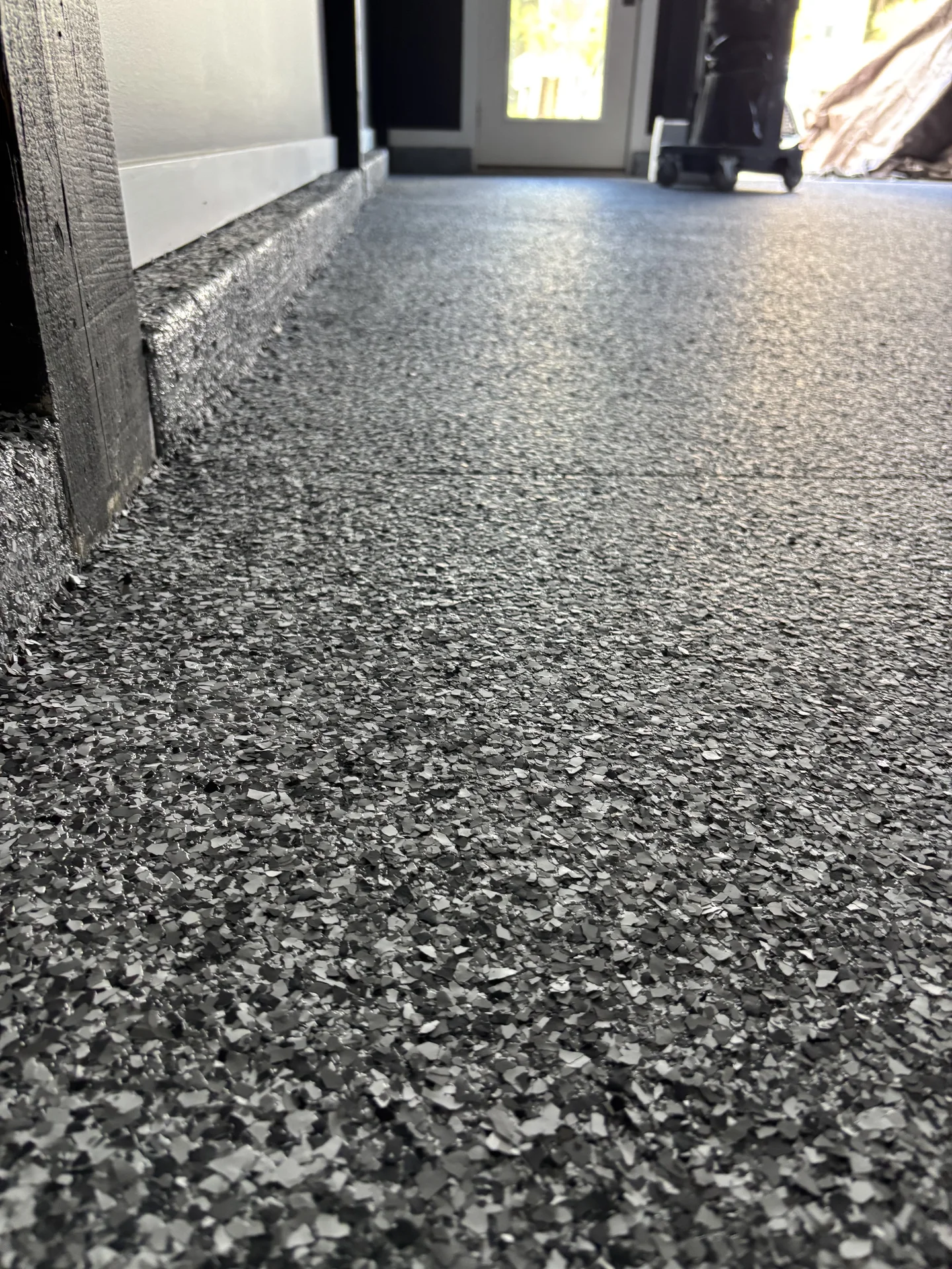 Close view of a dark decorative flake garage floor