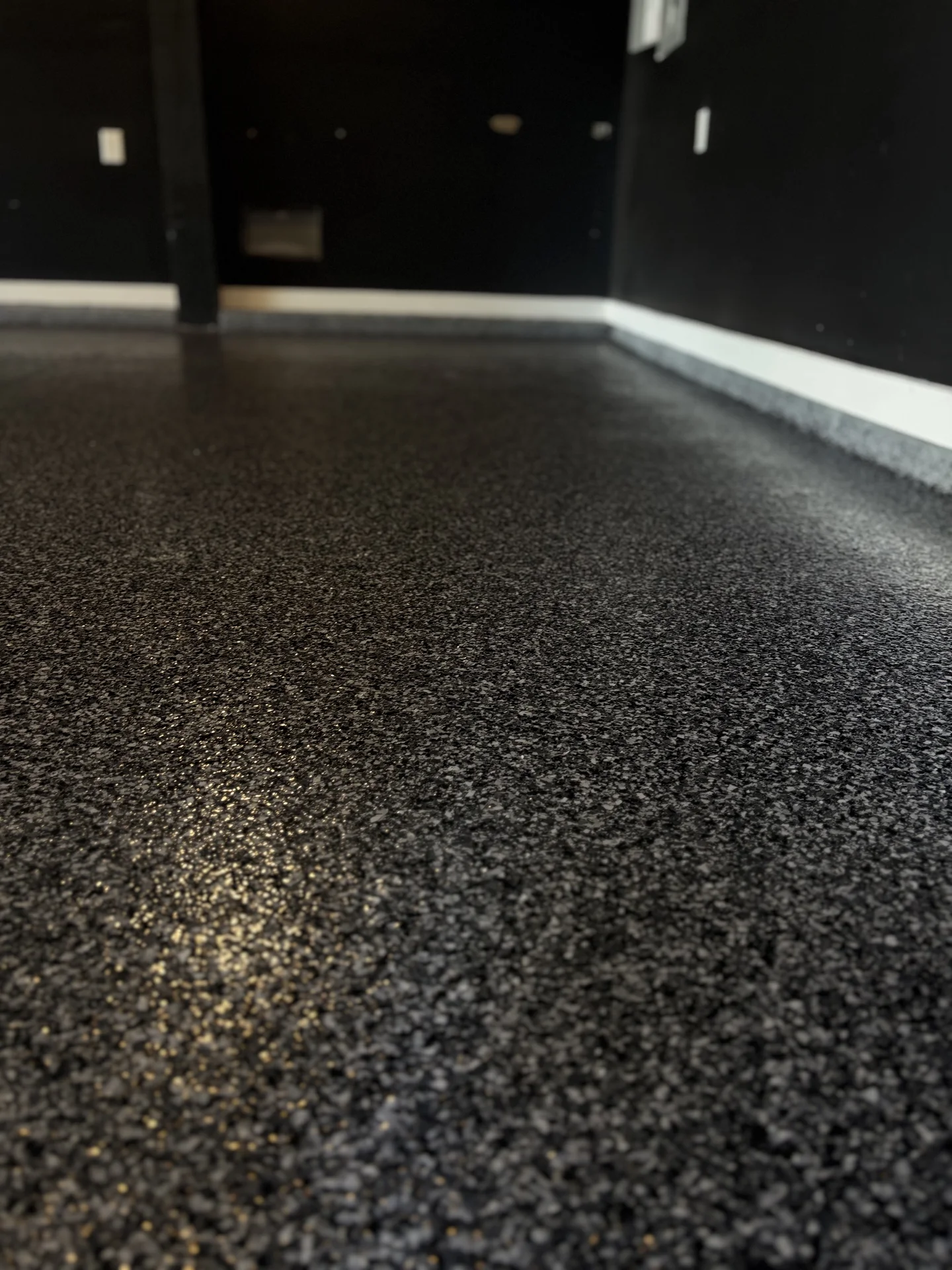 Finished dark flake coating in a residential garage