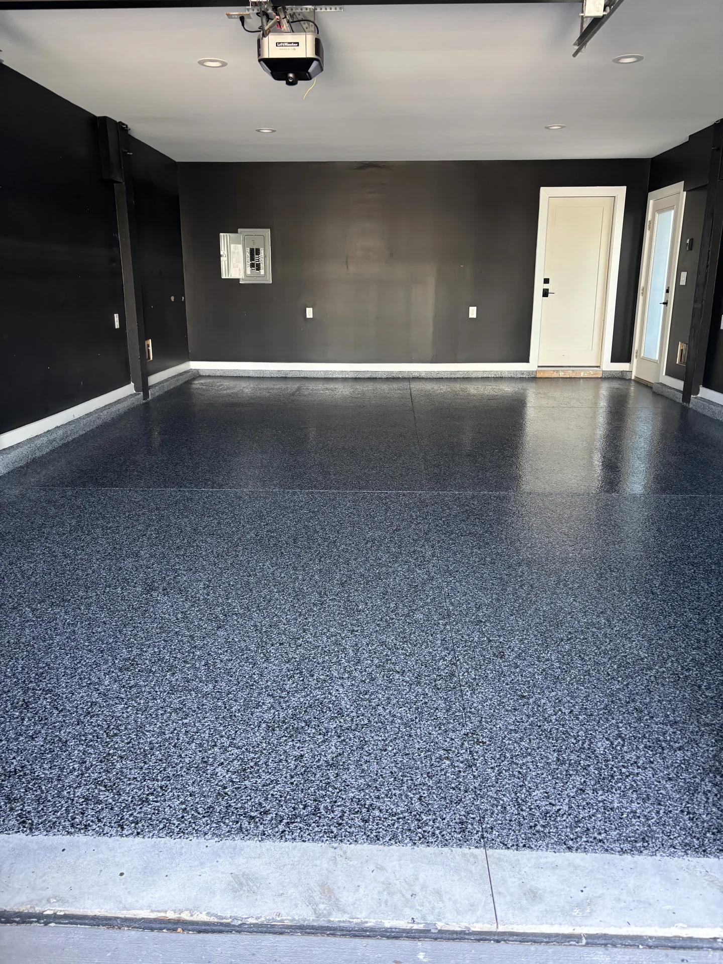 Finished garage with a dark gray flake floor